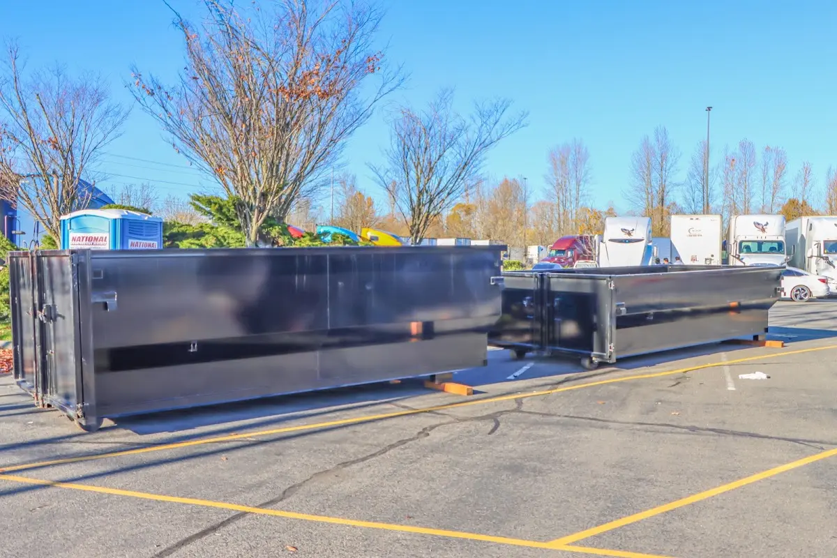 Professional dumpster rental service with roll-off container on residential driveway in Collier